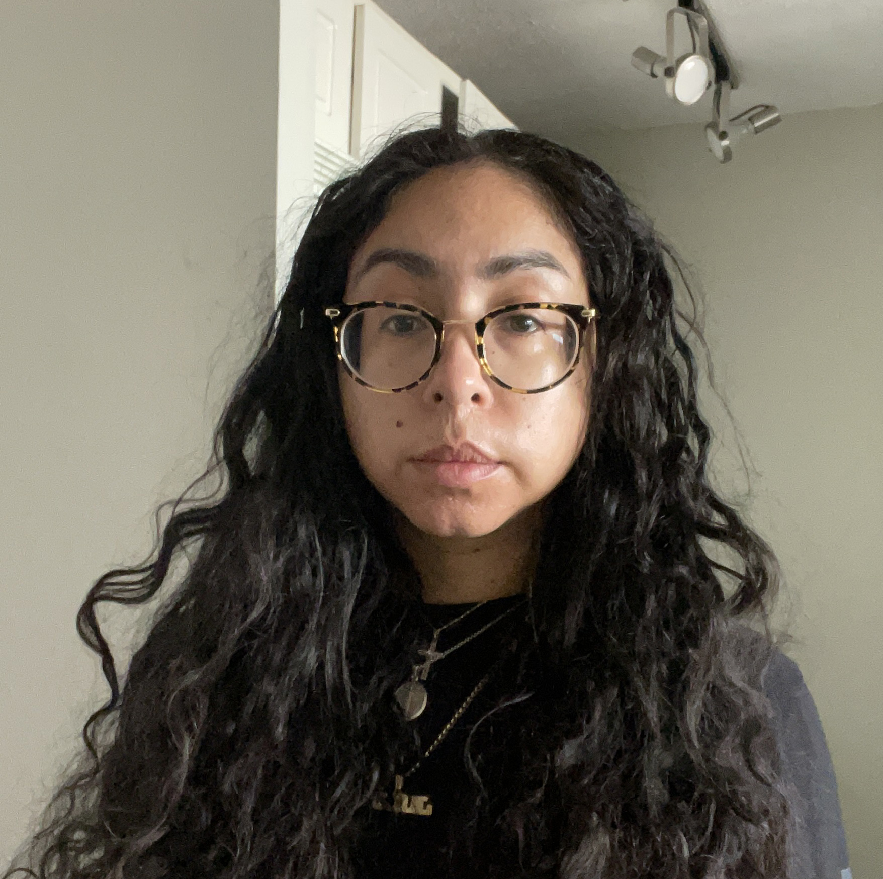 Photograph of Jennifer Ferretti; dark hair; dark shirt; dark glasses.